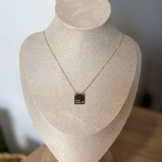 Necklace with a pendant on a mannequin bust against a neutral background